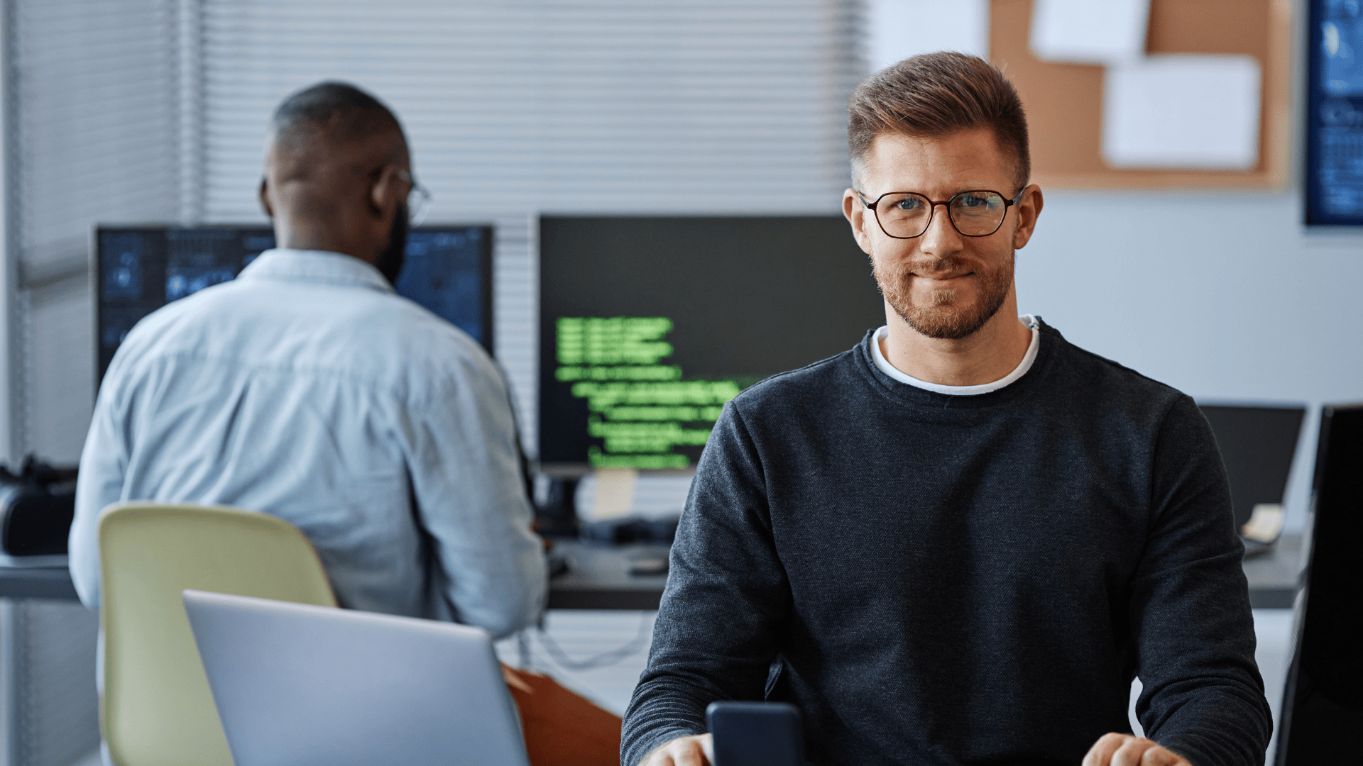 Auf dem Bild ist ein Mann in einem Büro zu sehen. Es dient der Veranschaulichung der Arbeitsumgebung im angebotenen Job.